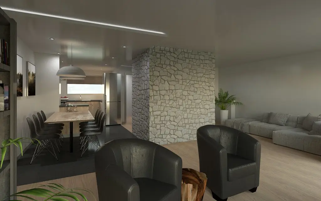 An open living and dining room with leather chairs and a stone-clad column